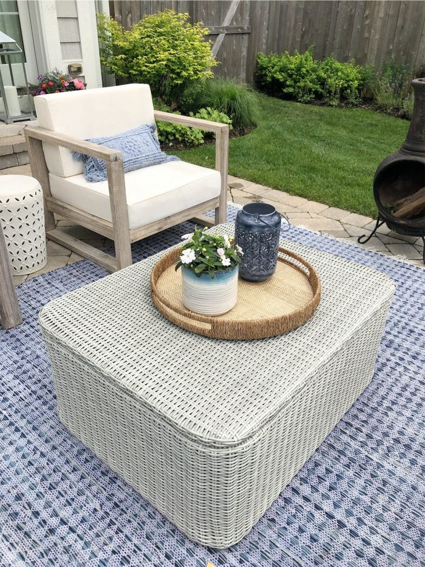 outdoor seating area, chair and coffee table on a blue outdoor rug