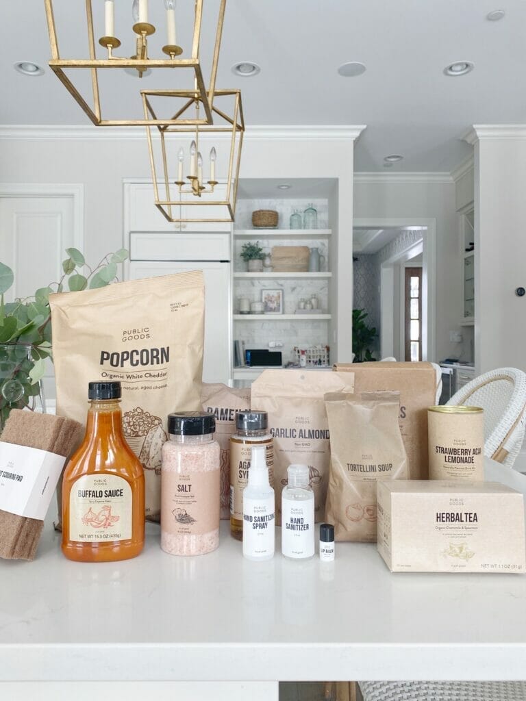 Shopping Clean Essentials with Public Goods | Pretty white kitchen features open shelving, brass fixtures, benjamin moore classic gray walls and ceasarstone frosty carrina countertops.
