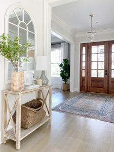 Console and entryway table styling, arched mirror, pretty decor finds, faux greenery, functional storage all help to create a beautiful and welcoming entryway.