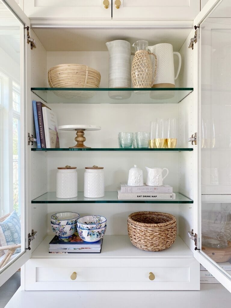 Walmart spring decor trends in a open cabinet including canisters, bowls and trays