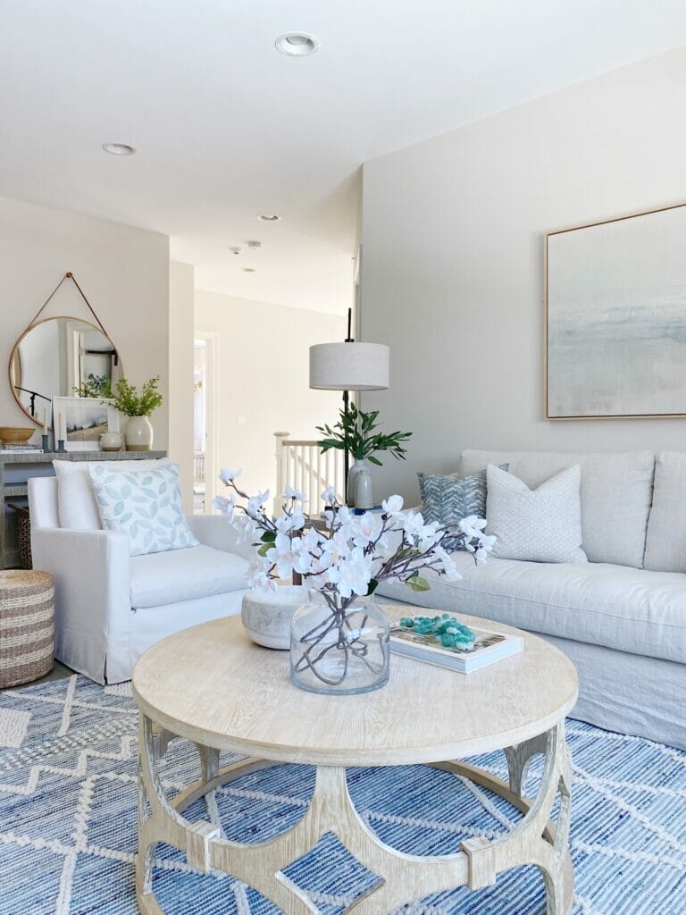 Sharing My Favorite Rugs in Our Home | Living room features Serena & Lily Ryder denim rug, Benjamin Moore classic gray walls, pretty abstract art and Ikea farlov sofa, swivel chairs and simple coffee table styling.