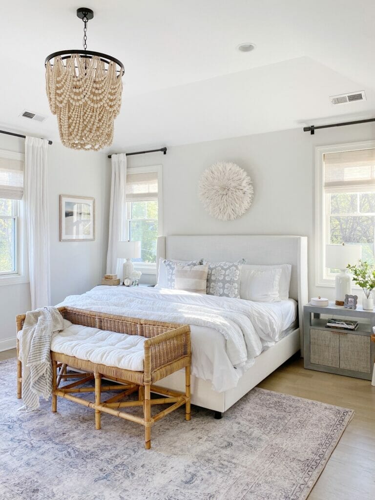 Sharing My Favorite Rugs in Our Home | Bedroom features pretty neutral styling, Loloi Loren rug in slate, upholstered bed, rattan bench, benjamin moore classic gray walls. 