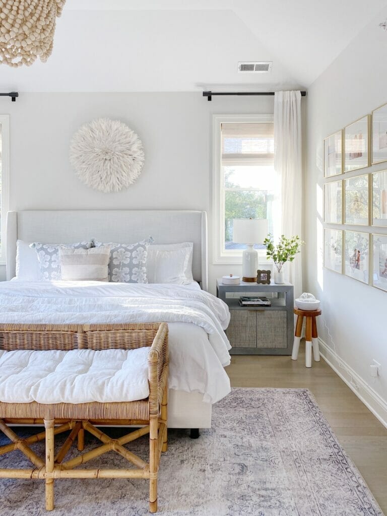 Loloi Rugs in My Home | Bedroom features pretty neutral styling, Loloi Loren rug in slate, upholstered bed, rattan bench, benjamin moore classic gray walls. 