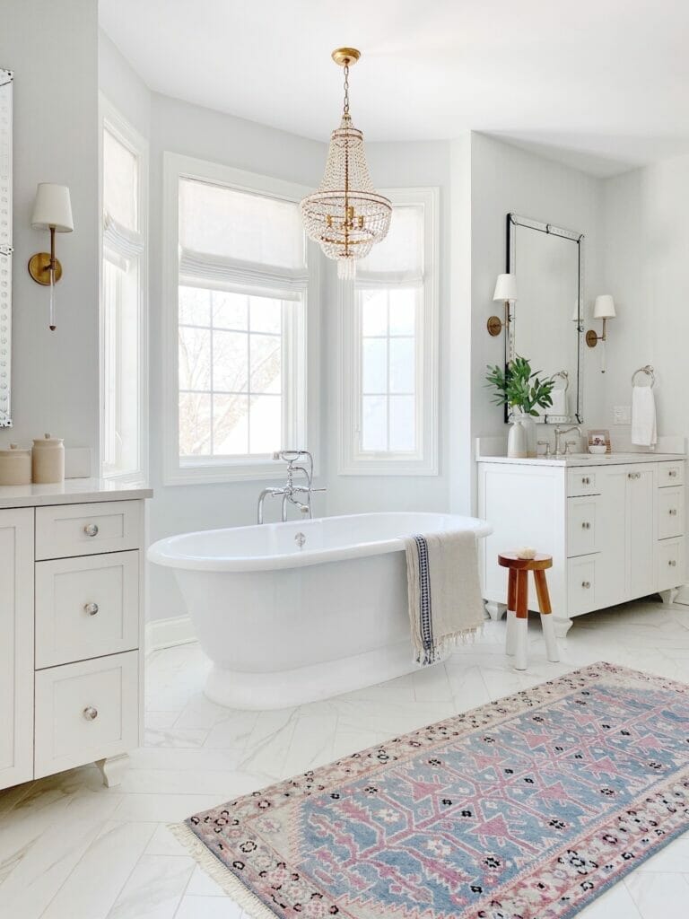 Bathroom features this beautiful Caitlin Wilson runner, herringbone tile, a freestanding tub and double vanities.