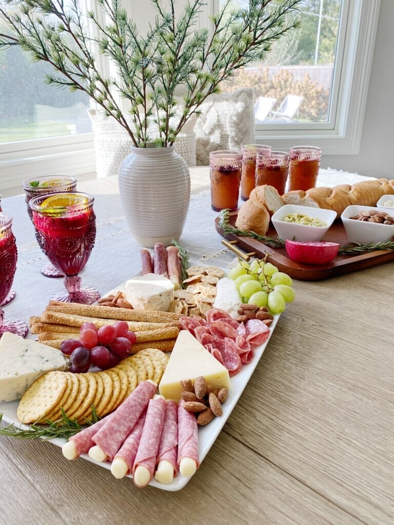 holiday hosting with walmart featuring festive cocktails and a charcuterie board