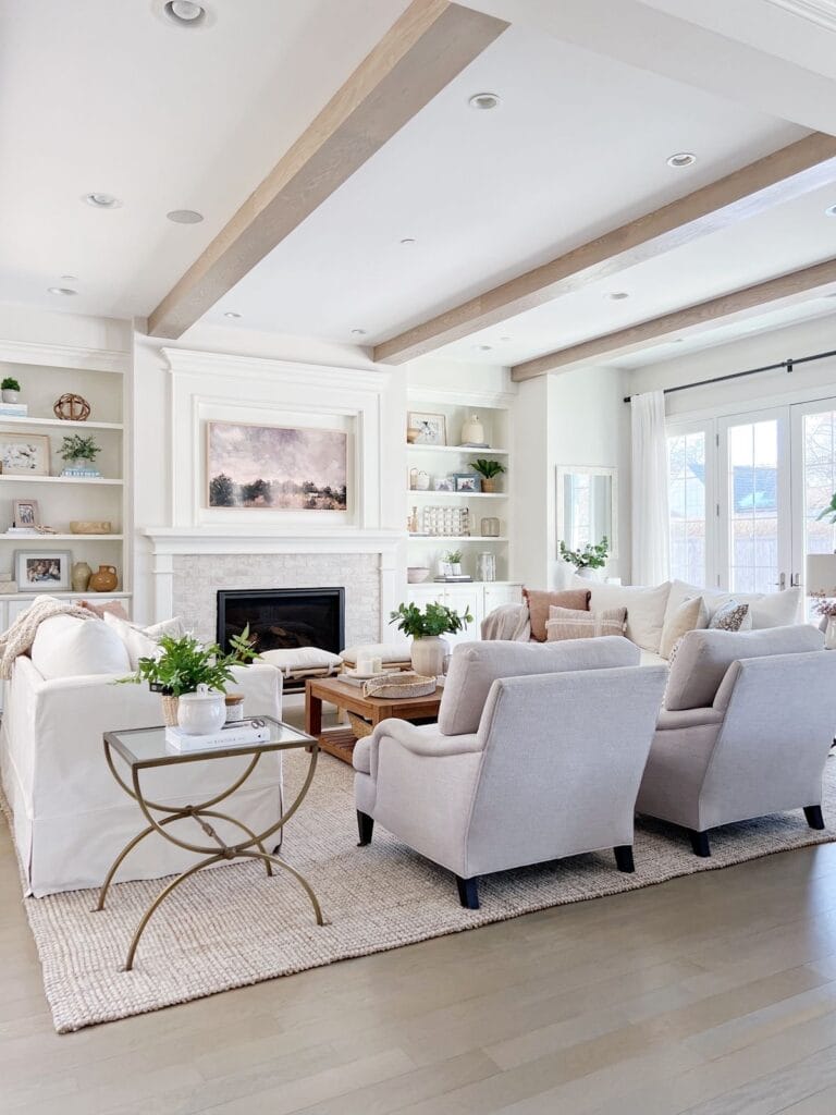 living room with white walls and beams on the ceiling