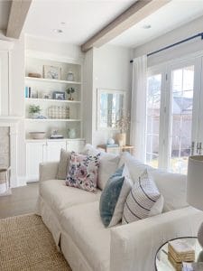 neutral room with couch and bookcase