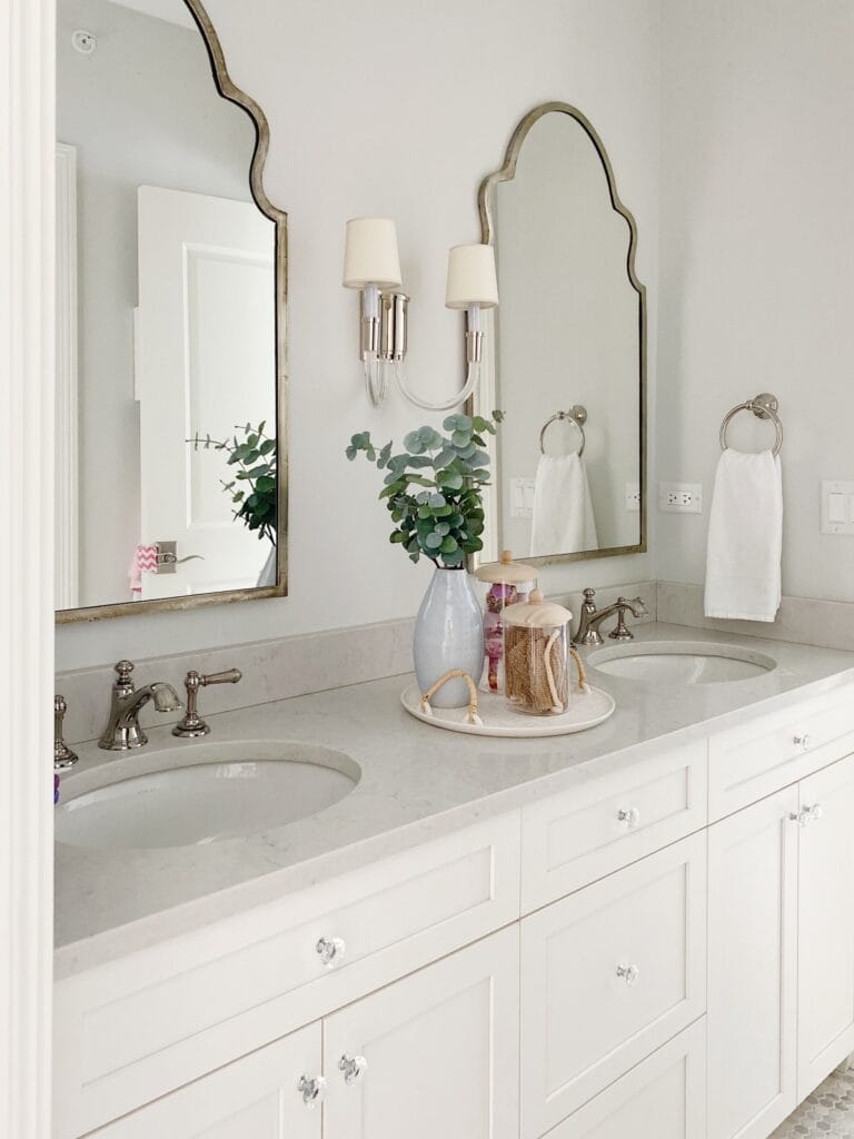 white vanity with two bathroom mirrors
