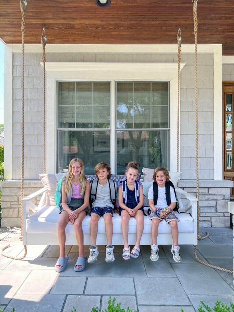 4 siblings sitting on the porch